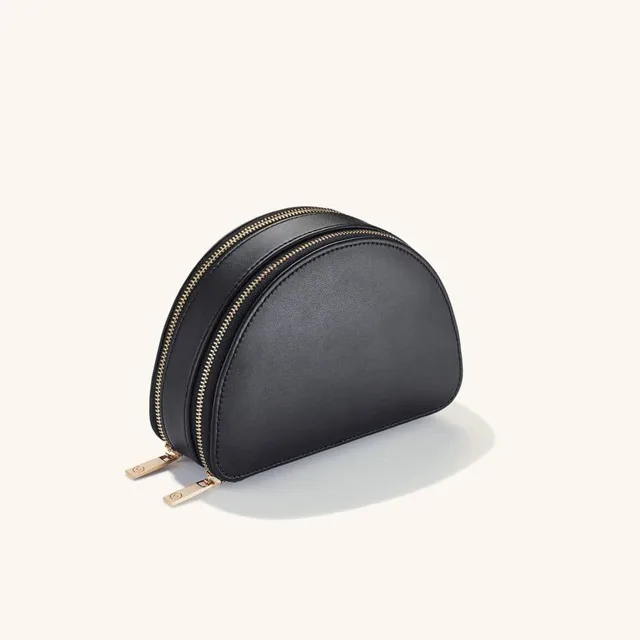Black quilted jewelry pouch closed, front view, gold zipper