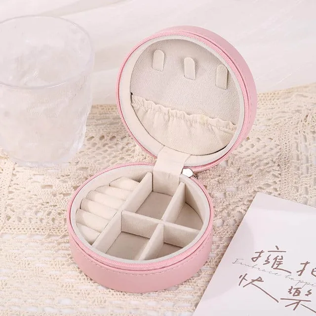Pink round travel case open showing the mirror and five slots