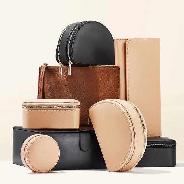 Black, brown and tan zippered pouches arranged as a group