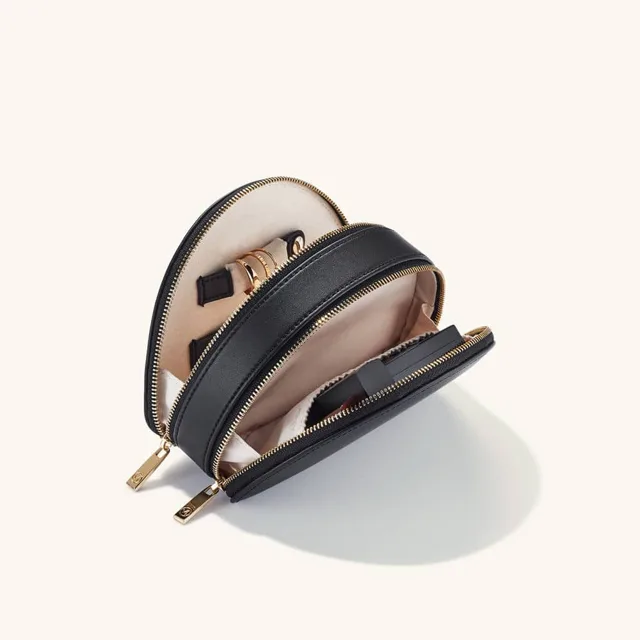 Close view of the half-open black jewelry pouch interior