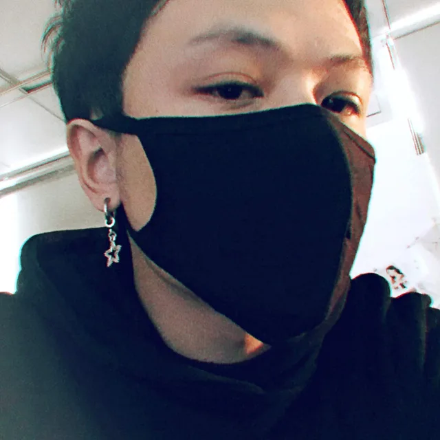 Model in dark clothing wearing the silver star earrings