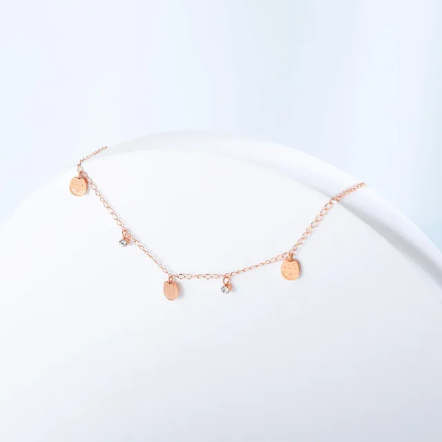Disc anklet arranged on a white dish