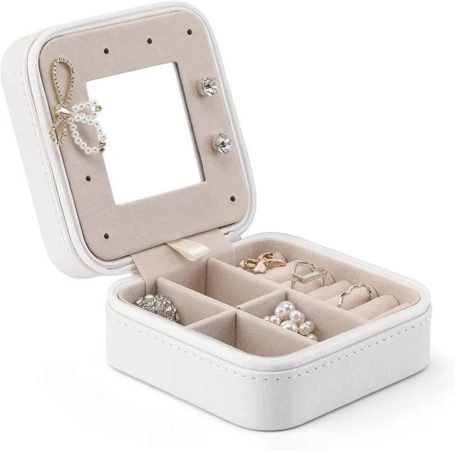 White square jewelry case open showing the mirror and ring rows