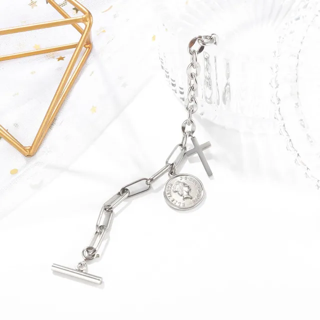 Silver coin and cross bracelet with a toggle clasp