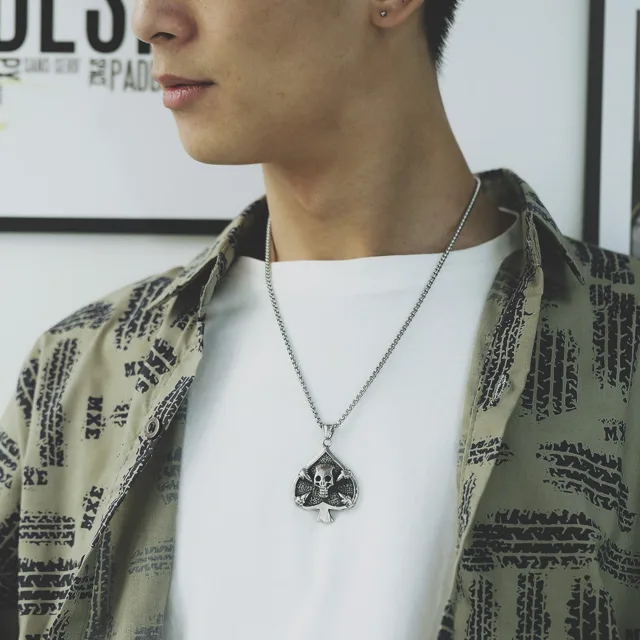 Model in a printed shirt wearing the spade pendant