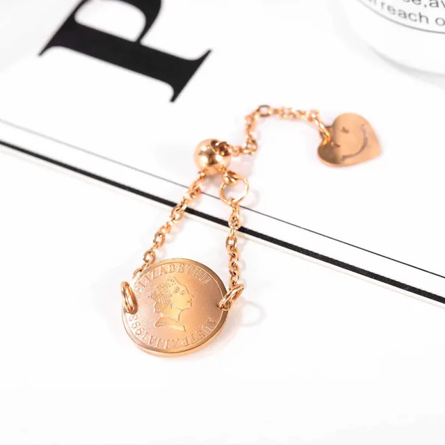 Rose gold chain ring laid beside a letter card