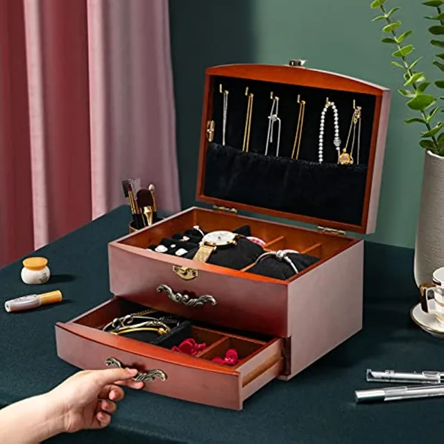 Hand sliding a drawer of the vintage wooden chest open