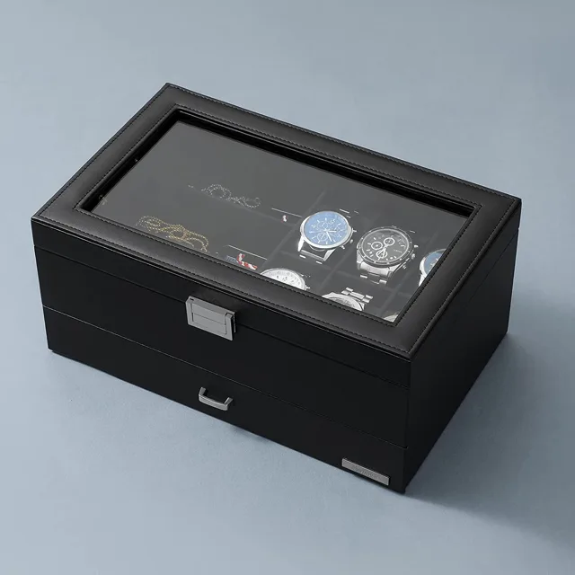 Black leather watch box closed against a pale blue backdrop