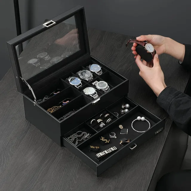 Hands placing a watch into the open black storage box