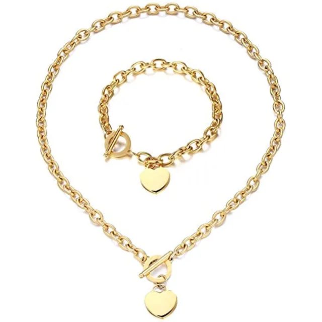 Gold heart necklace and bracelet set laid out together