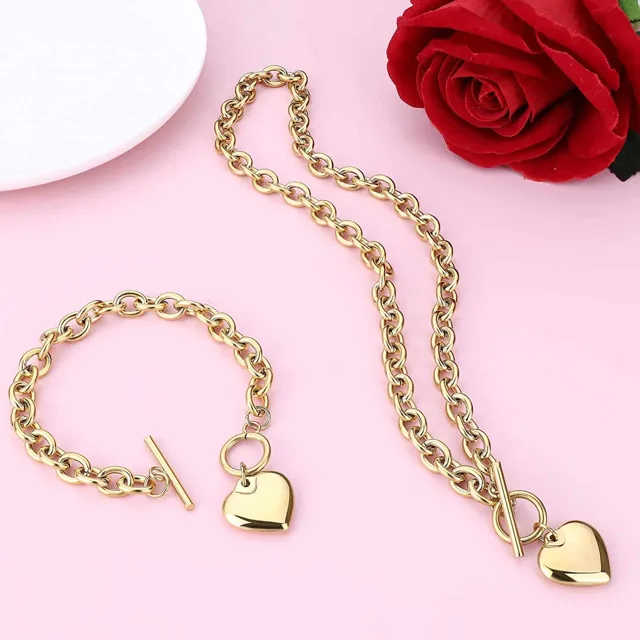 Rose gold heart set laid on pink with a rose