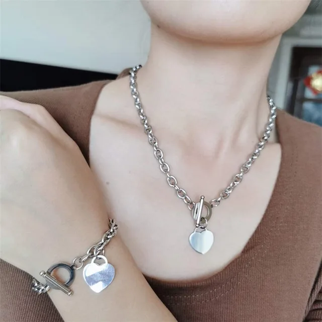 Model wearing the silver heart pendant and bracelet set