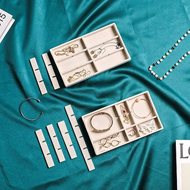 Trays styled with chains and hoops on a green velvet backdrop