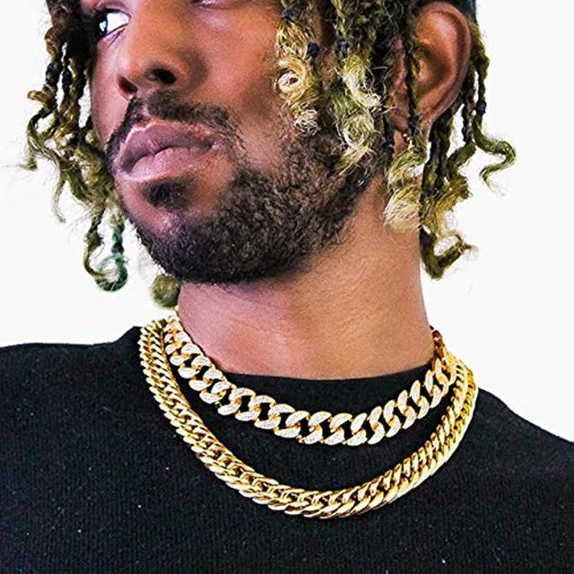 Man wearing layered black and gold Cuban link chains