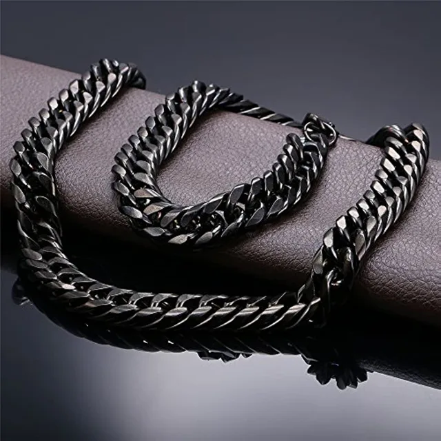 Black Cuban link chain coiled on a dark surface