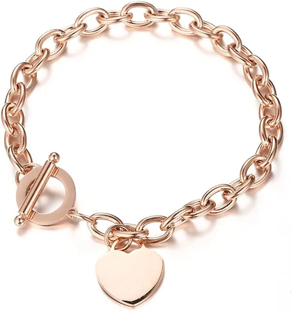 Close view of a rose gold heart charm and OT clasp bracelet