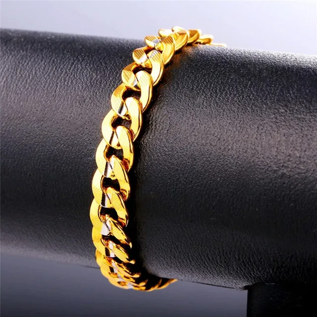 Gold Cuban link bracelet worn on a mannequin wrist