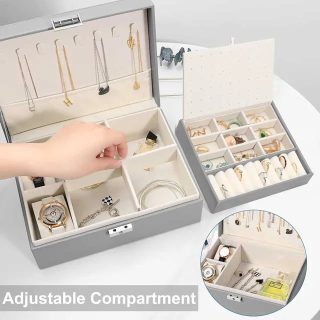 Hand opening the grey jewelry box to the adjustable tray