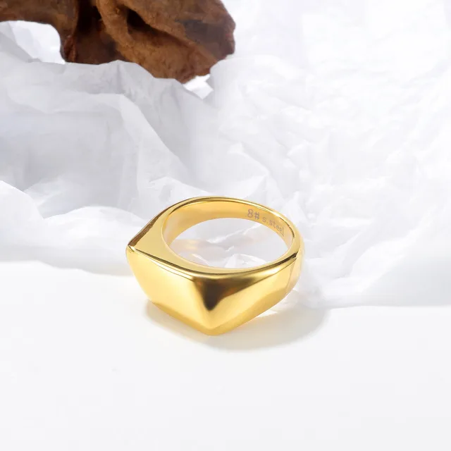 Gold dome ring on white linen