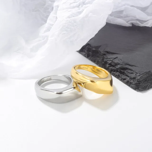 Gold and silver dome rings on a marble tray