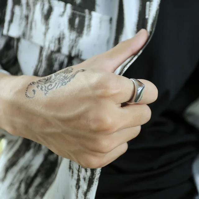 Man's hand wearing the silver dome ring