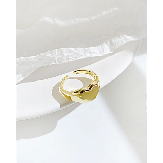 Gold heart ring on a white dish