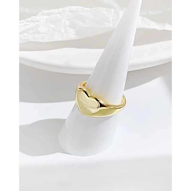 Gold heart ring on a ring cone
