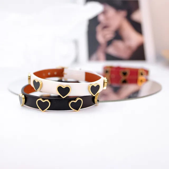 White and black heart-stud bracelets stacked