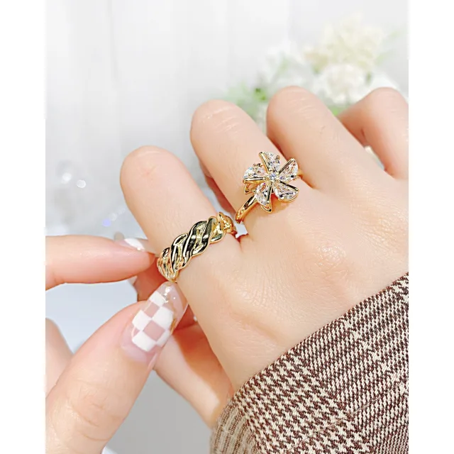 Hand wearing the twisted gold open ring
