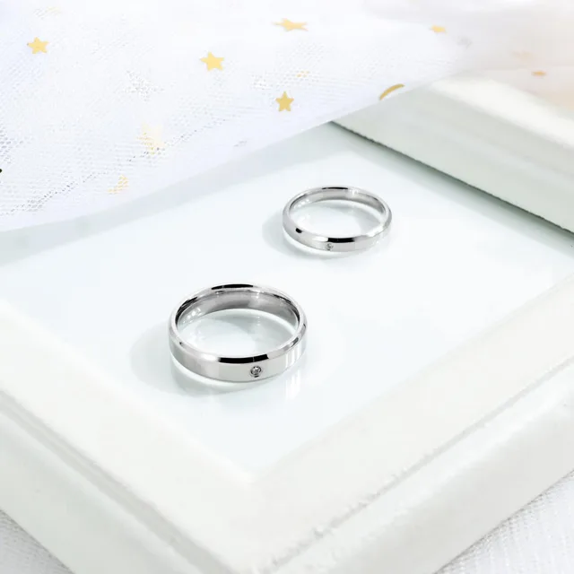 Wedding bands laid on a white photo frame