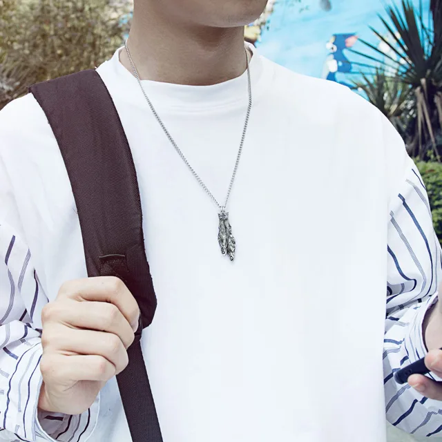 Man in white wearing the silver fish pendant