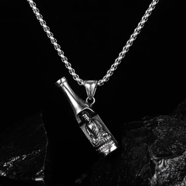 Silver bottle pendant on black fabric, close view
