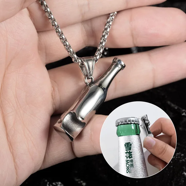 Hand holding the pendant beside a small opener tool
