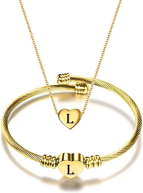 Gold set with letter L engraved on heart and cuff