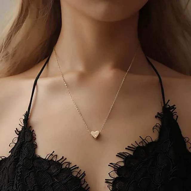 Model wearing the gold heart pendant necklace