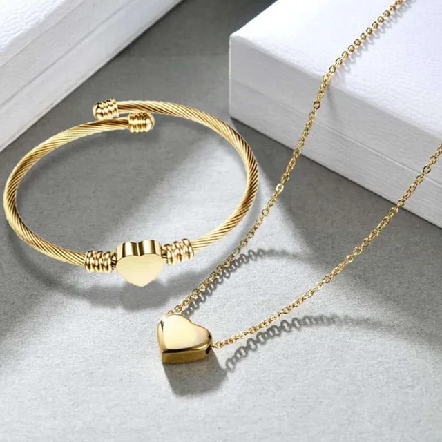 Gold heart bracelet and necklace set on a book background
