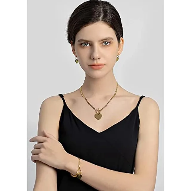 Model wearing the gold heart chain, studio shot