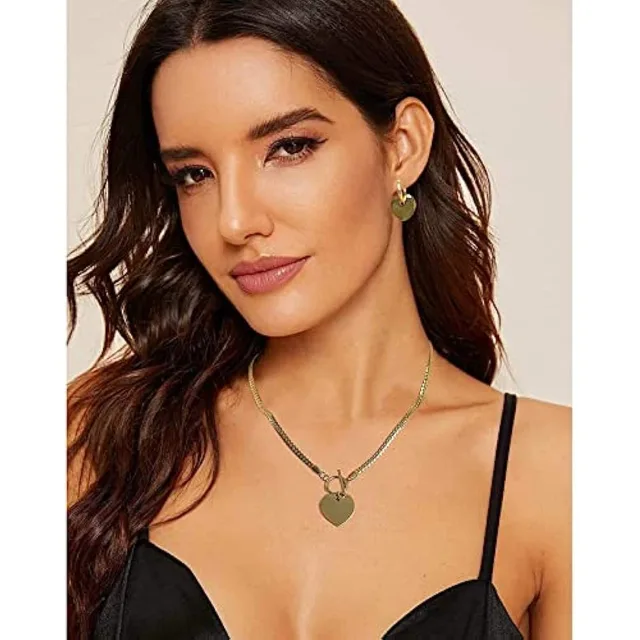 Model in a black top wearing the gold heart necklace