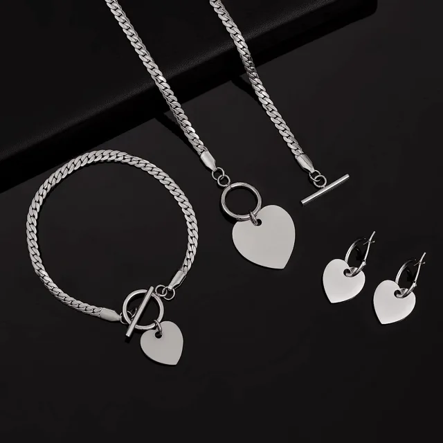 Silver heart set arranged on dark fabric