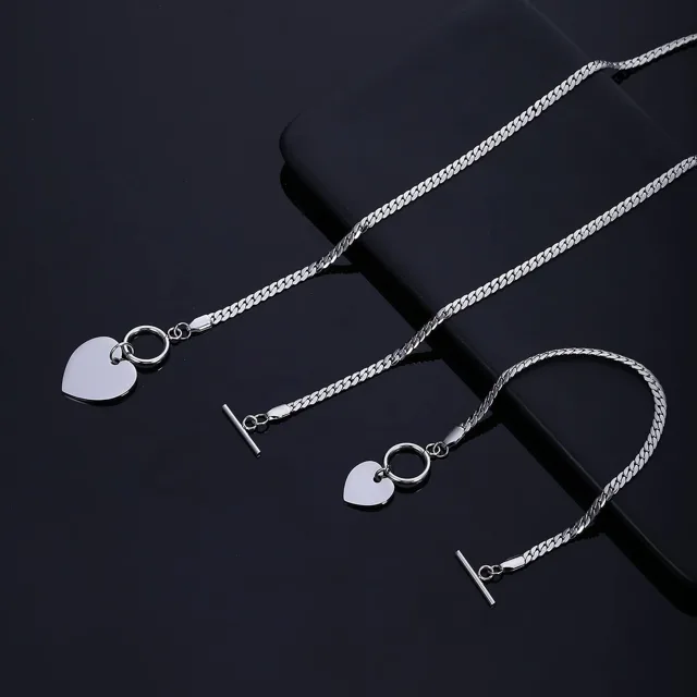 Silver heart necklace and bracelet on black
