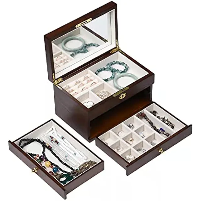Wooden chest with two drawers slid open and jewelry inside