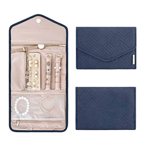 Navy jewelry roll with its removable zip pouches laid out