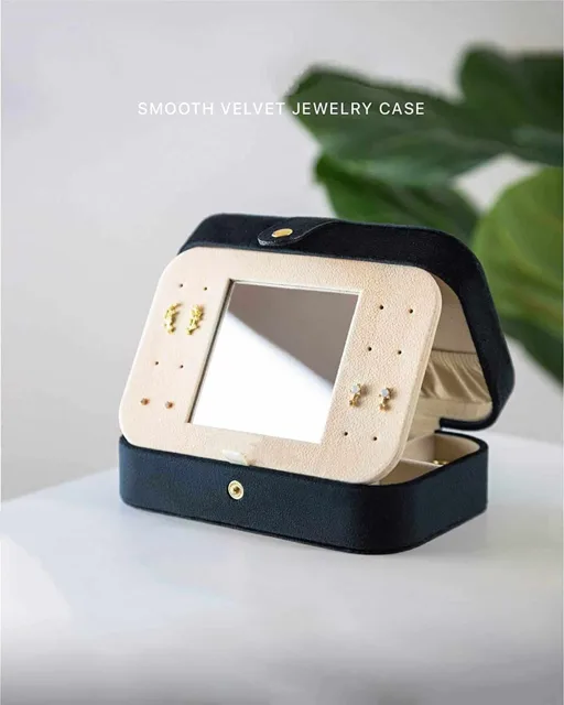 Black travel case styled open against a green backdrop