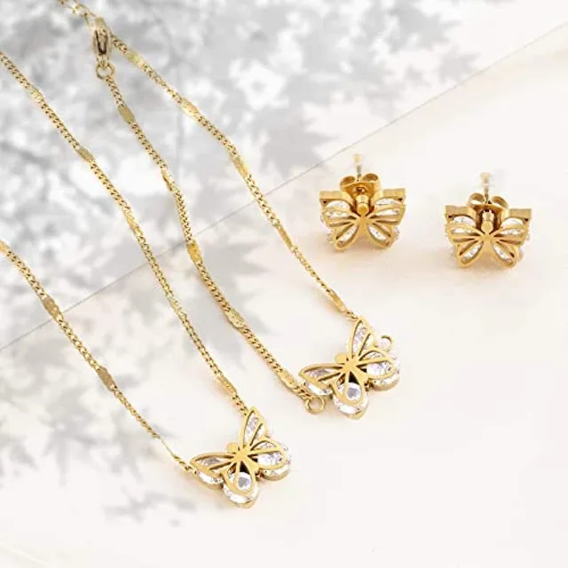 Gold butterfly necklace and studs on white tulle