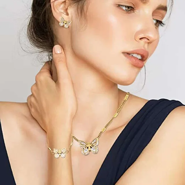 Model in navy wearing the gold butterfly necklace