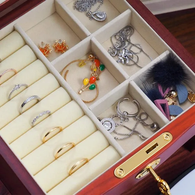 Close view of a red chest drawer holding rings and bangles