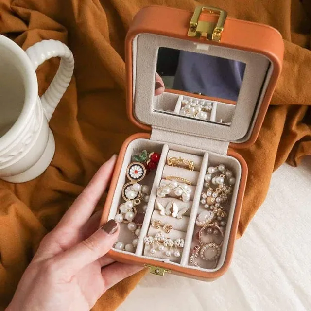 Hands holding the caramel case open beside a coffee cup