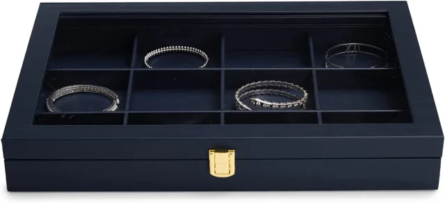 Open navy case holding bracelets in a divided tray