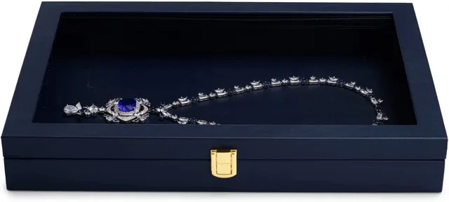 Open navy display case holding a silver necklace on a white background