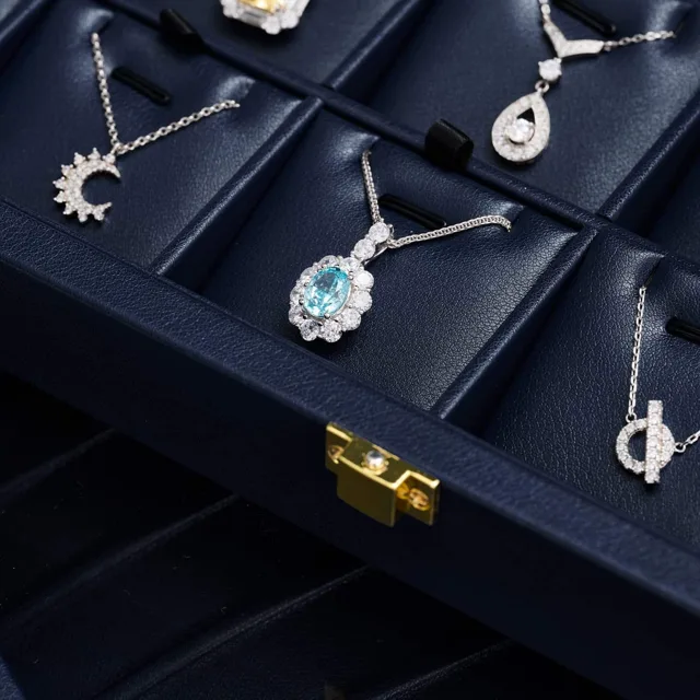 Moon and star pendant necklaces hung inside a navy display case